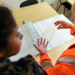 5 Smart Steps to Hire a Contractor with Confidence 1 Two engineers reviewing construction blueprints on a table in an office setting.