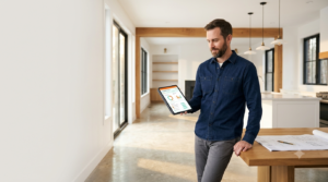 A general contractor reviews a milestone dashboard on a tablet in a premium renovation, illustrating contractor payment protection through escrow.