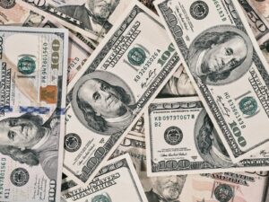 A scattered pile of American one hundred dollar banknotes